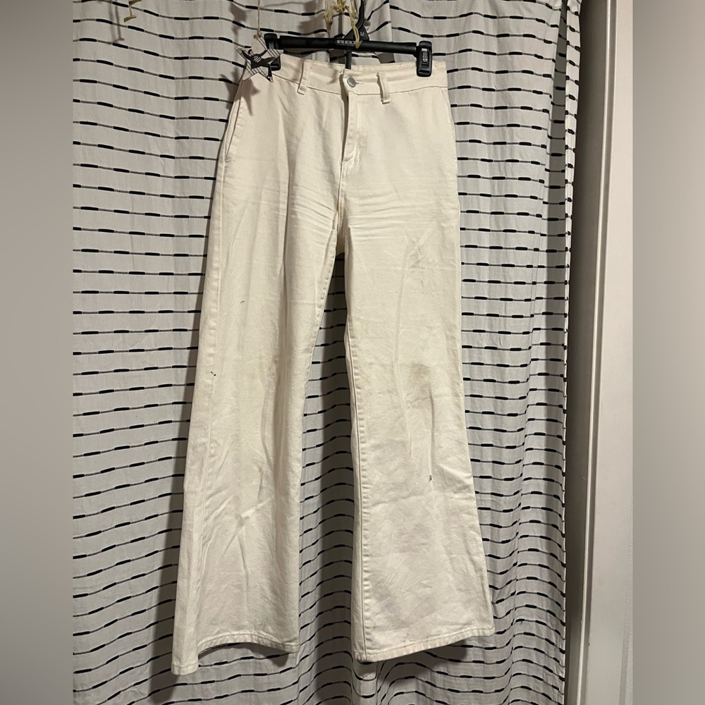 High waisted white flared pants.